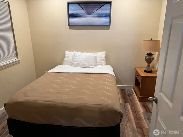 a bed sitting in a bedroom next to a window