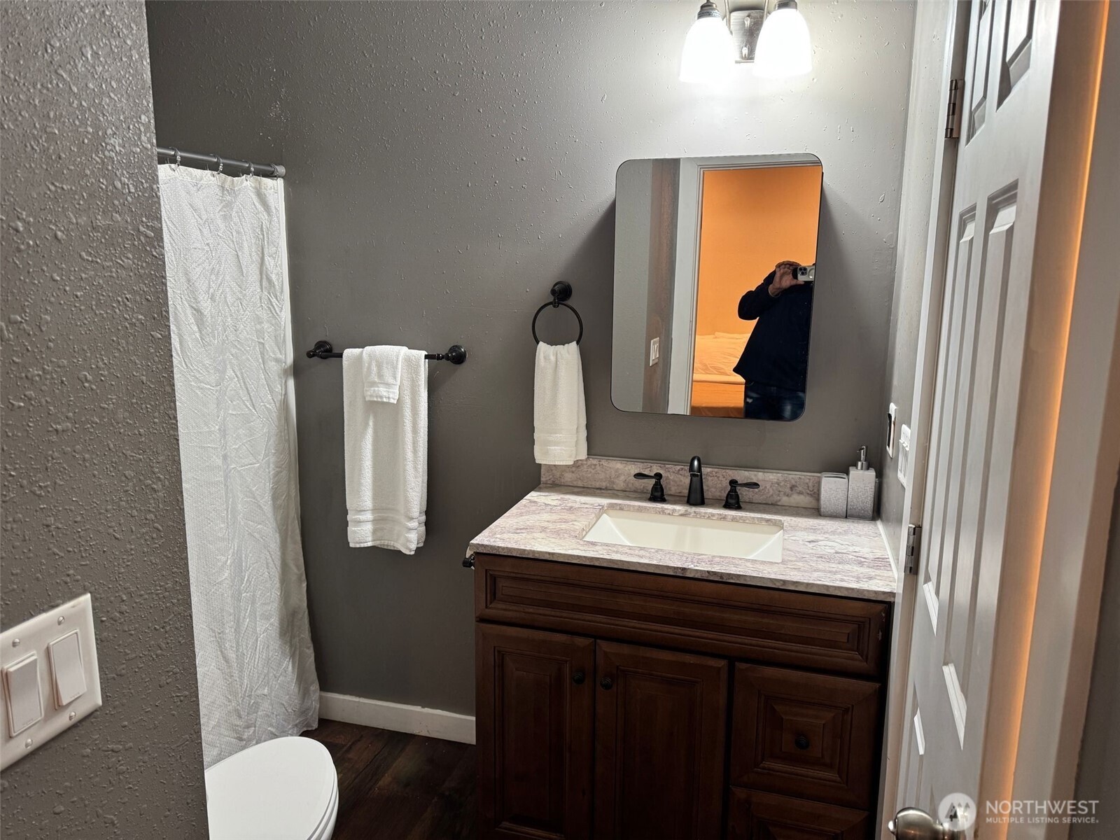 918 Orchard Avenue Gold Bar, WA 98251 - Photo 7 of 9 a bathroom with a granite countertop sink and a mirror