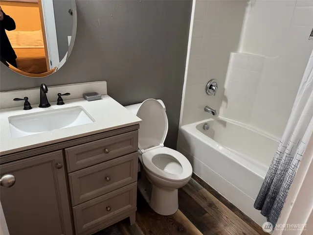 a bathroom with a toilet sink and mirror