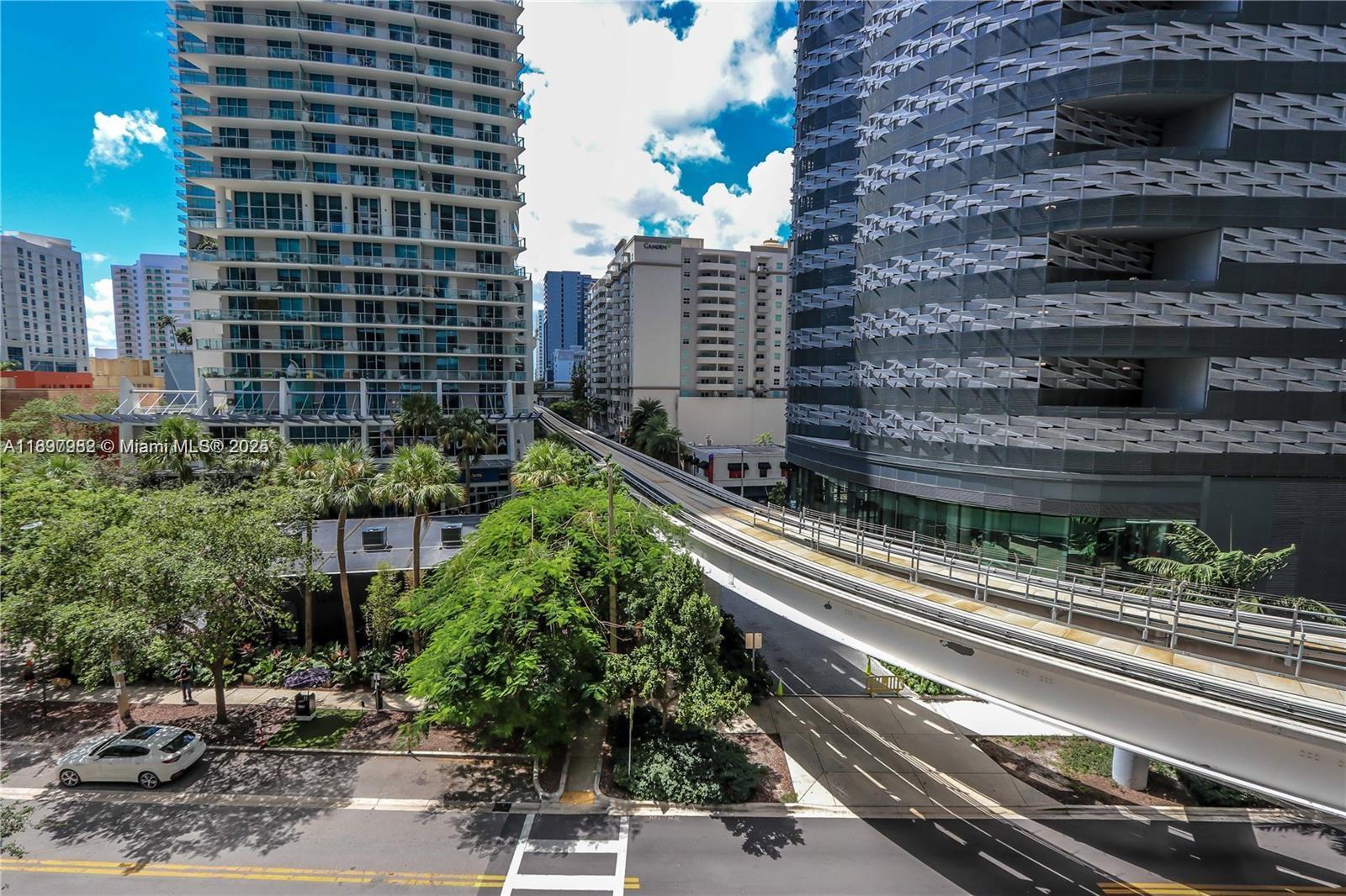 1050 Brickell Avenue, Unit 414 Miami, FL 33131 - Photo 11 of 42 a picture of a building with a couple of cars parked in front of it