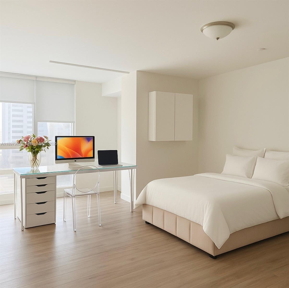 1050 Brickell Avenue, Unit 414 Miami, FL 33131 - Photo 13 of 42 a bedroom with a bed and a flat screen tv