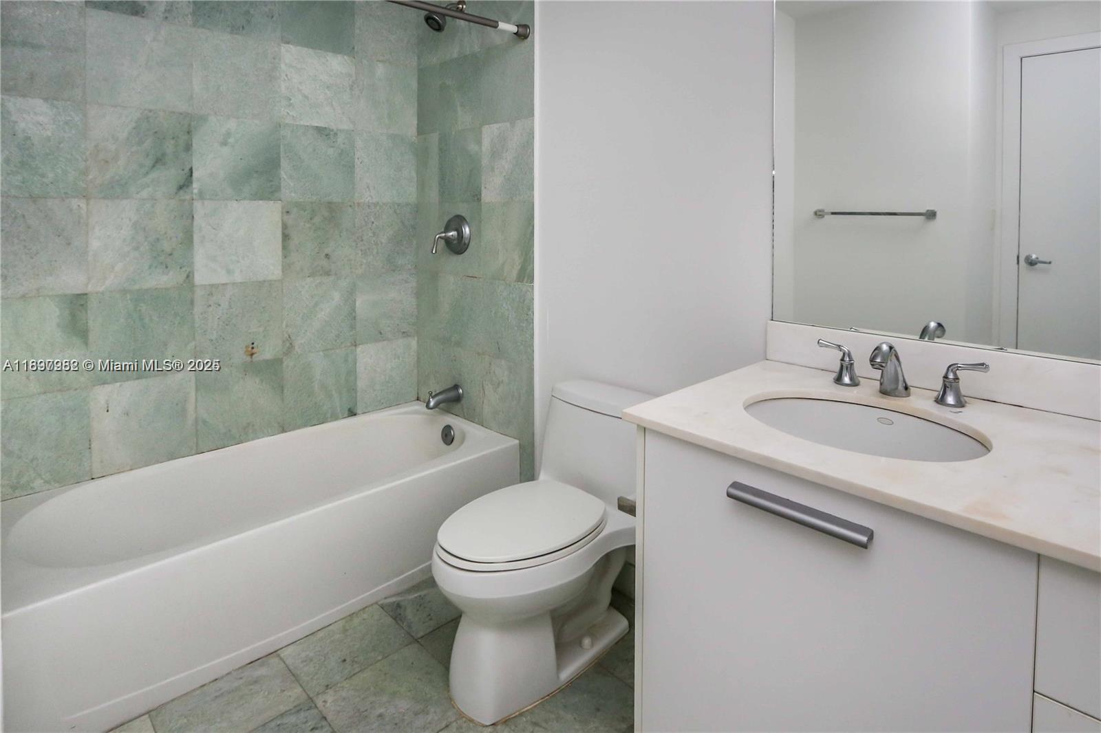 1050 Brickell Avenue, Unit 414 Miami, FL 33131 - Photo 16 of 42 a bathroom with a sink toilet and bathtub