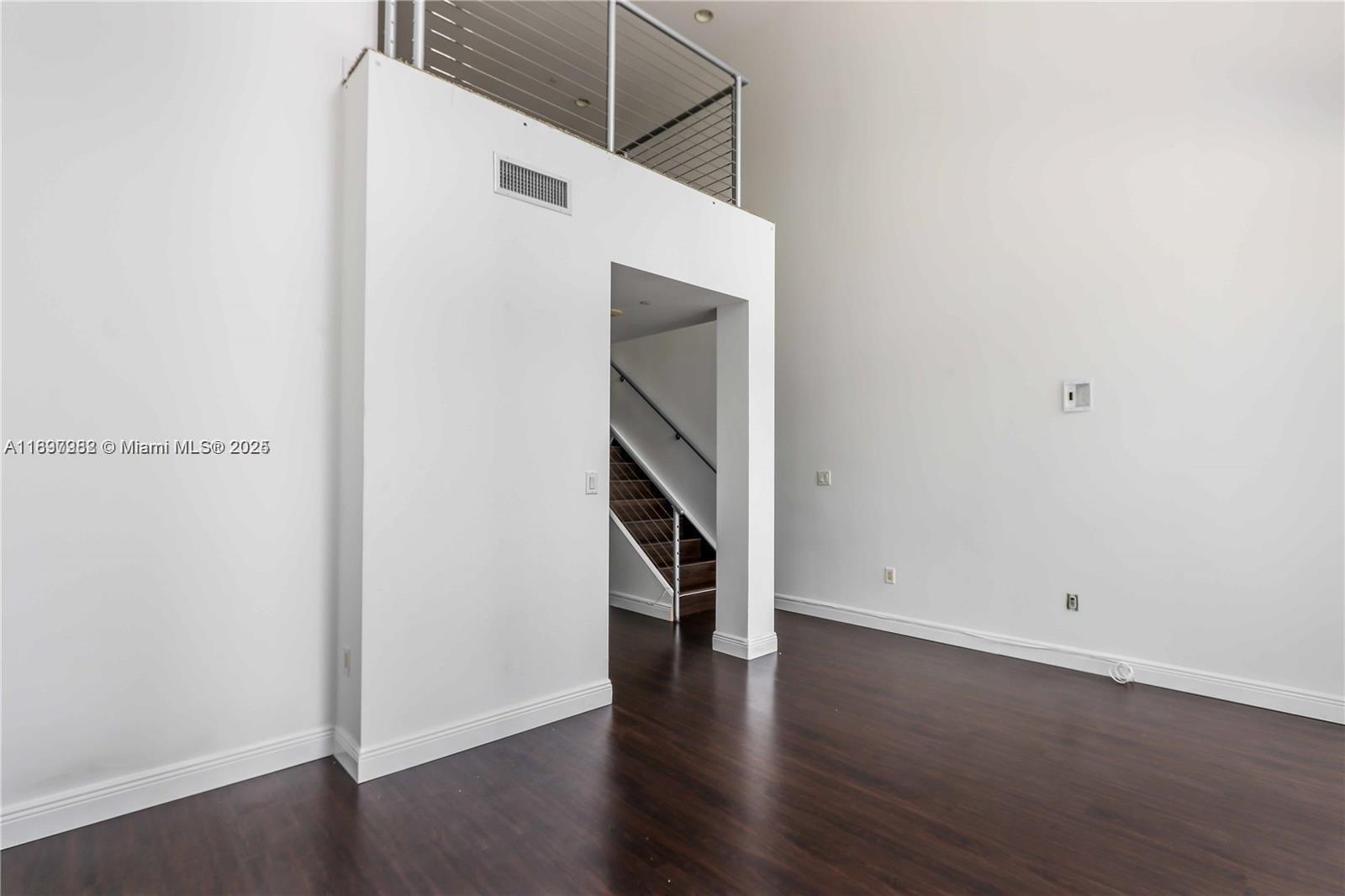 1050 Brickell Avenue, Unit 414 Miami, FL 33131 - Photo 17 of 42 a view of an empty room with wooden floor