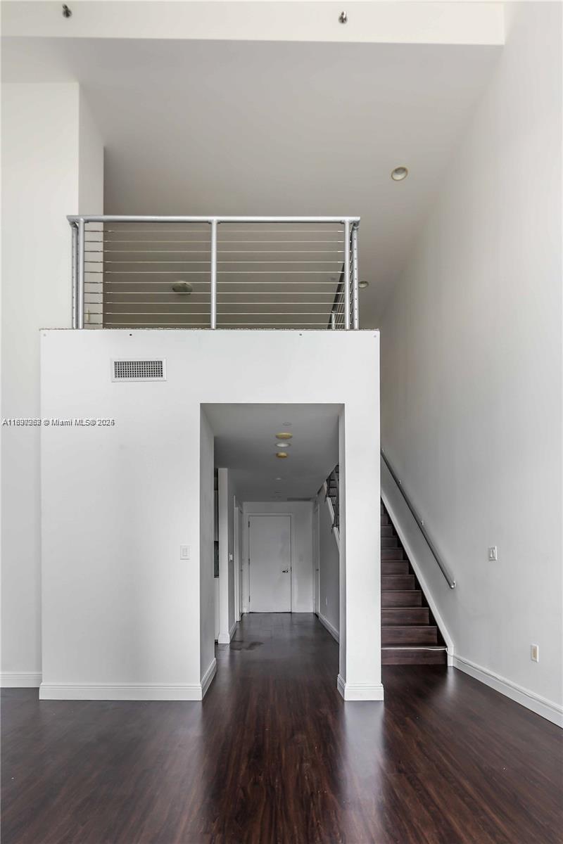 1050 Brickell Avenue, Unit 414 Miami, FL 33131 - Photo 18 of 42 a view of a hallway with wooden floor