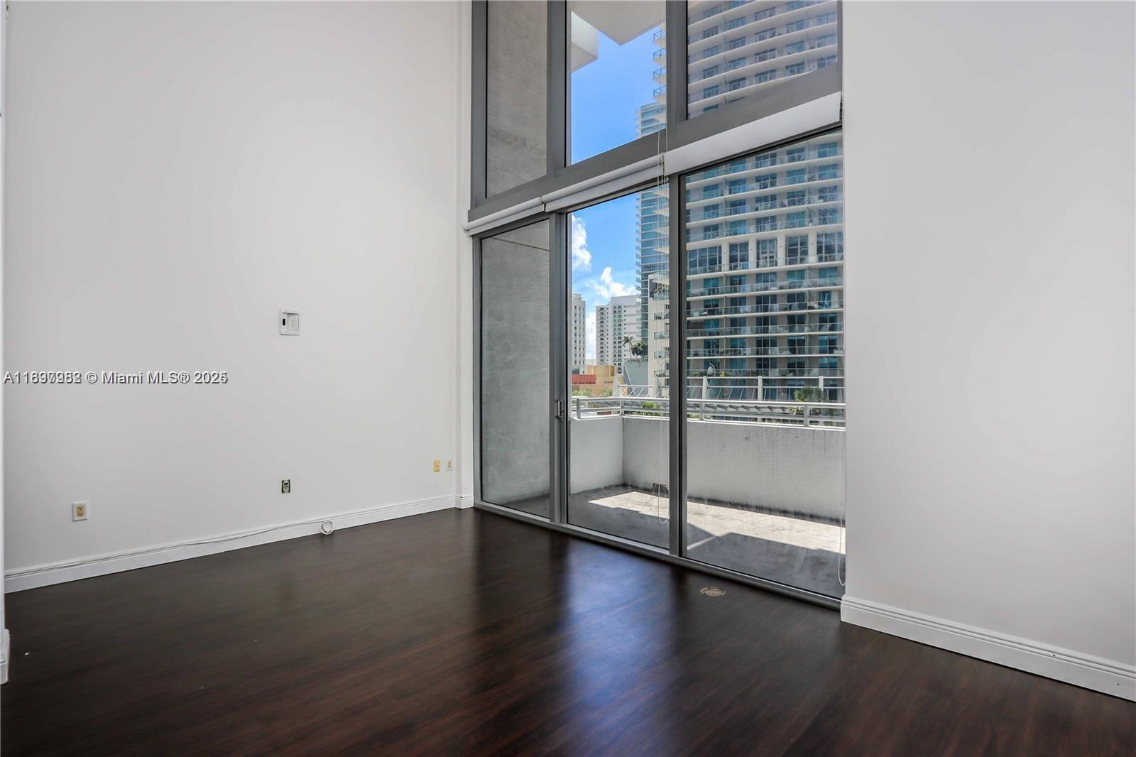 1050 Brickell Avenue, Unit 414 Miami, FL 33131 - Photo 2 of 42 a view of a room with wooden floor