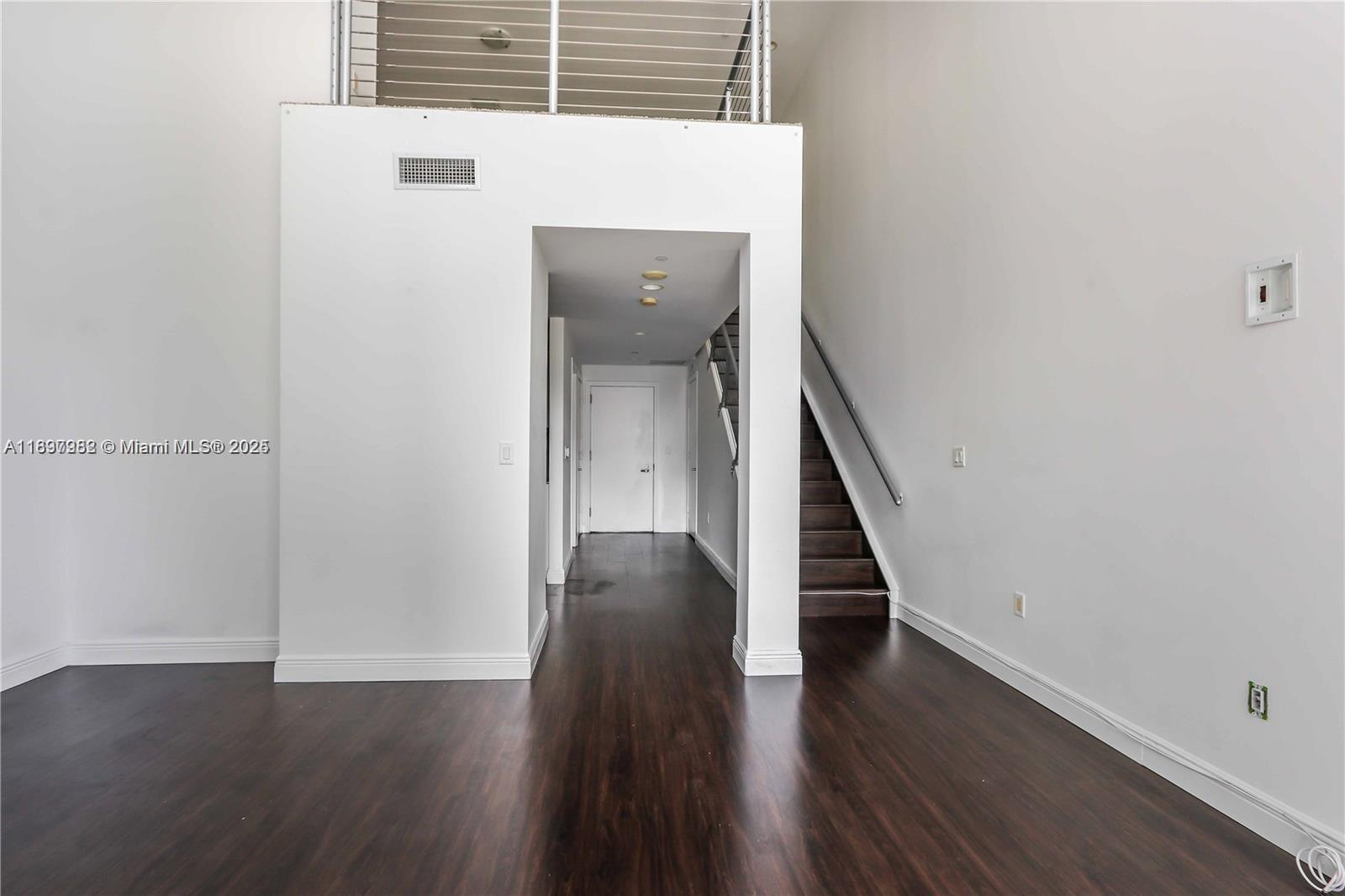 1050 Brickell Avenue, Unit 414 Miami, FL 33131 - Photo 21 of 42 a view of a hallway with wooden floor and staircase
