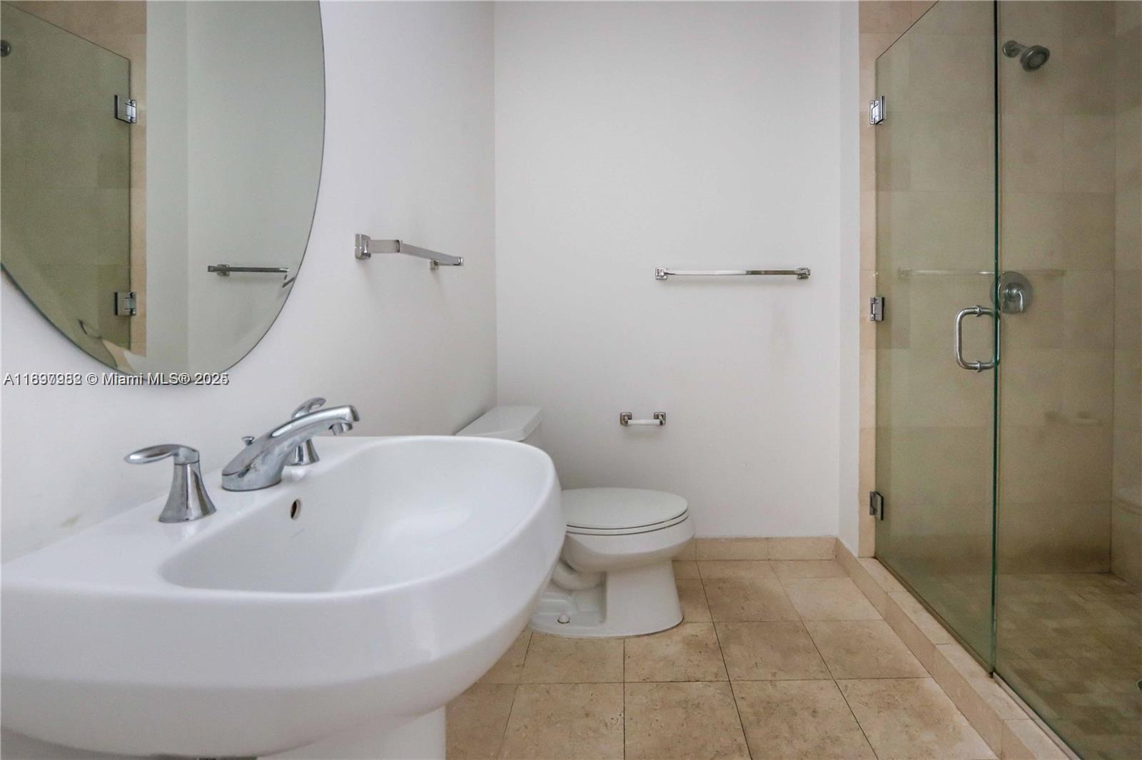1050 Brickell Avenue, Unit 414 Miami, FL 33131 - Photo 22 of 42 a white toilet sitting next to a bathroom sink