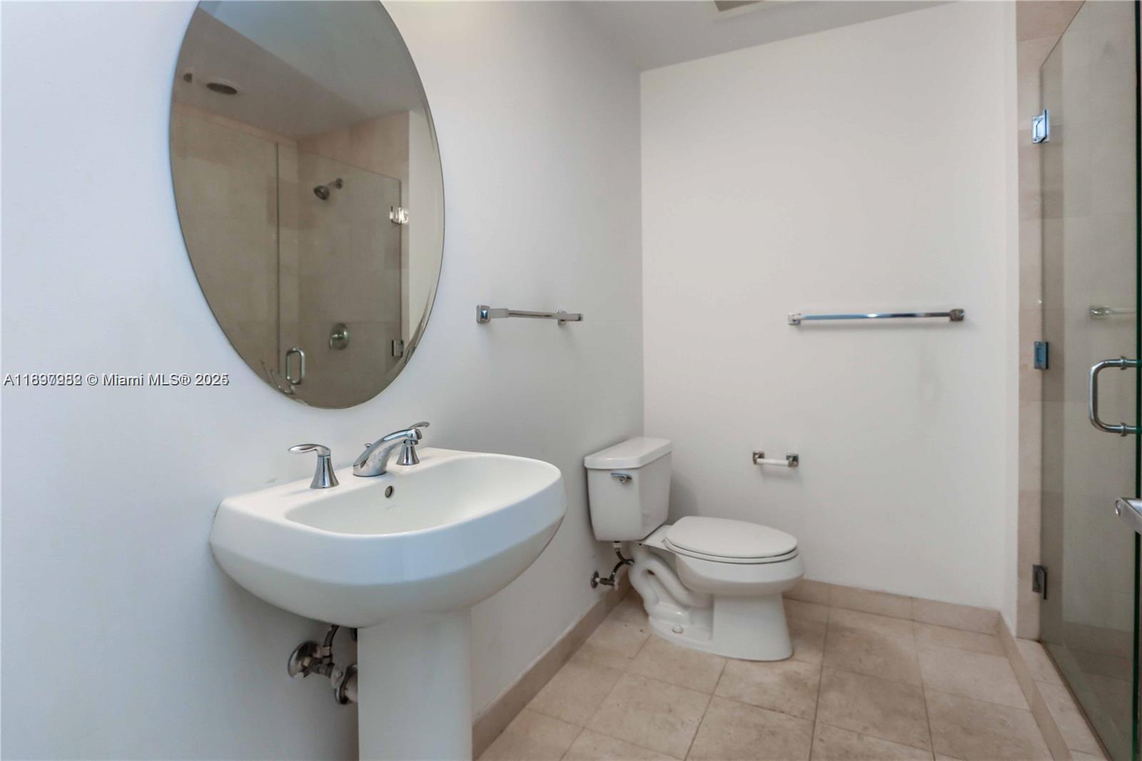 1050 Brickell Avenue, Unit 414 Miami, FL 33131 - Photo 23 of 42 a bathroom with a toilet sink and mirror