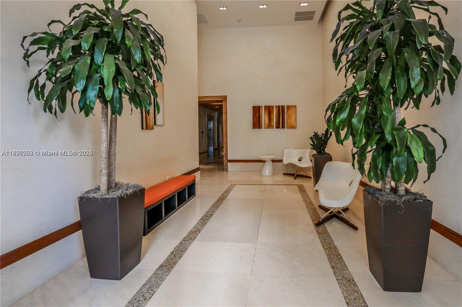 1050 Brickell Avenue, Unit 414 Miami, FL 33131 - Photo 34 of 42 a living room with furniture and a potted plant