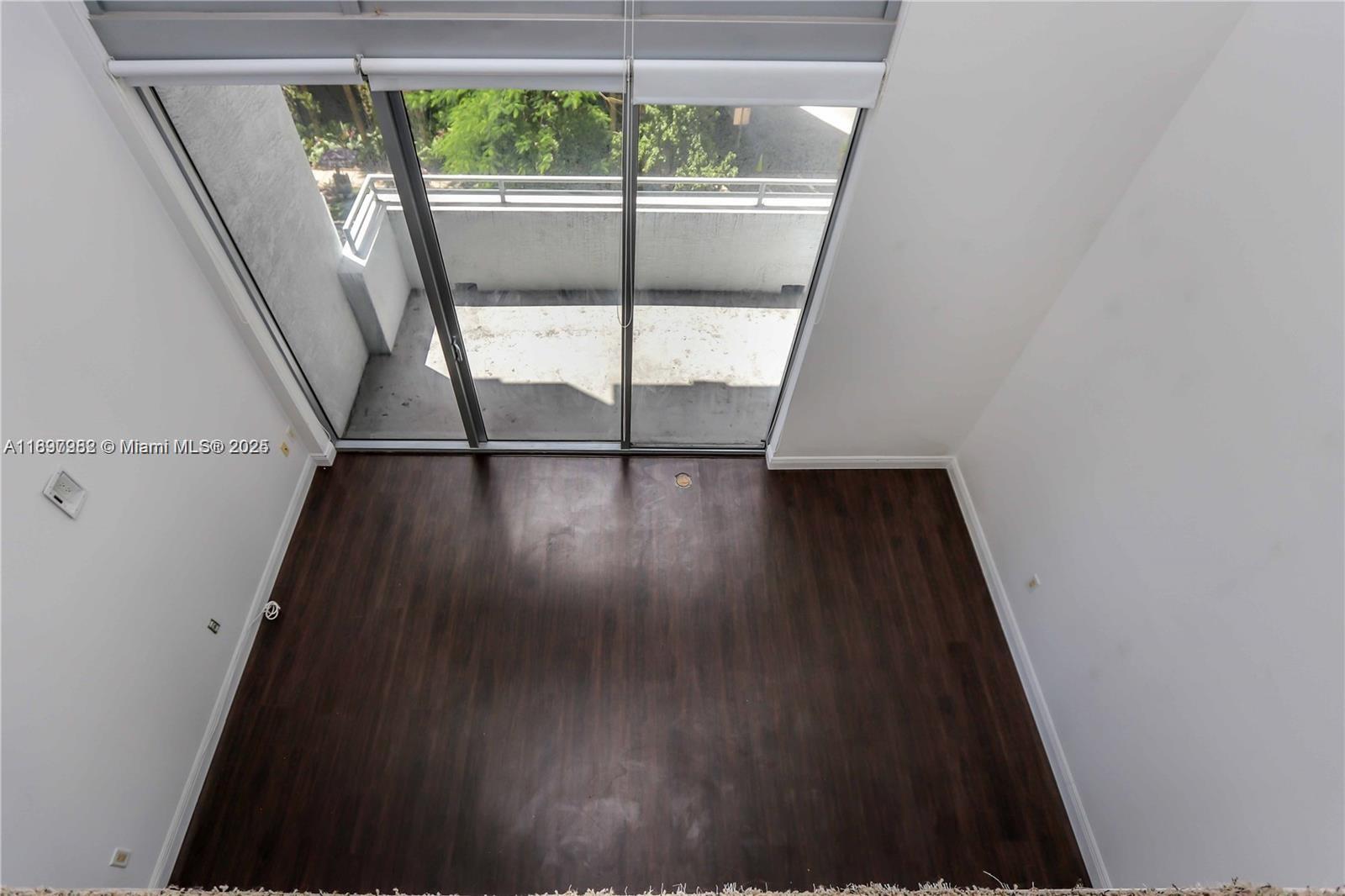 1050 Brickell Avenue, Unit 414 Miami, FL 33131 - Photo 5 of 42 wooden floor in an empty room with a window