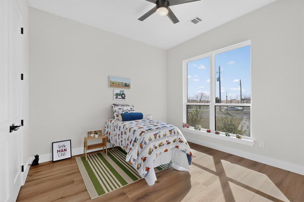 4961 County Road 1098 Celeste, TX 75423 - Photo 26 of 40 Bedroom featuring light wood-style flooring and ceiling fan