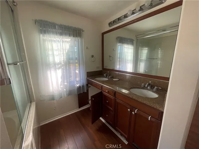 a bathroom with a sink a mirror and a shower