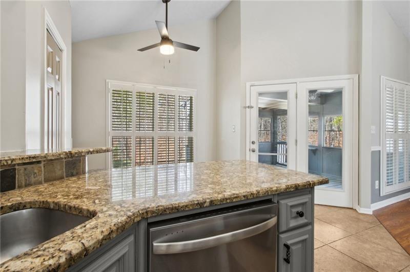 6604 Windbrook Way Flowery Branch, GA 30542 - Photo 24 of 64 a kitchen with granite countertop a sink and a window