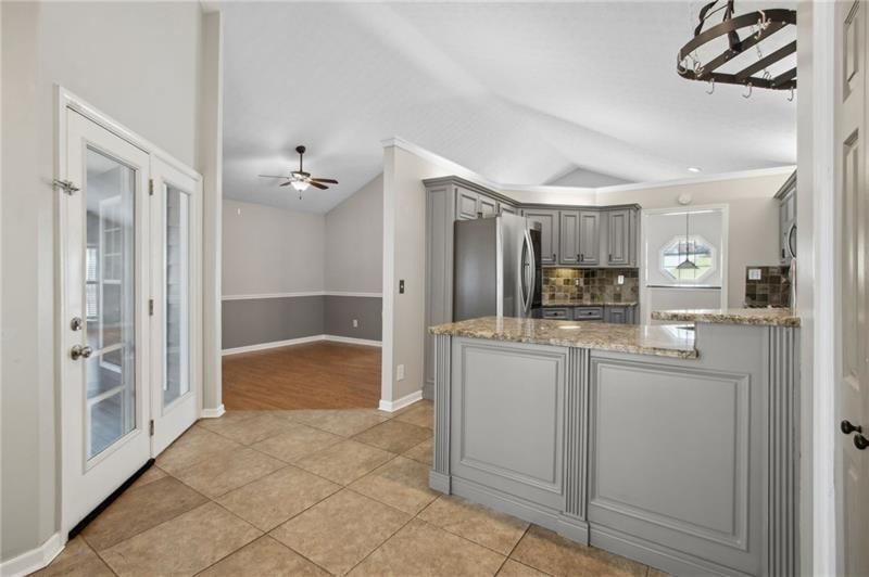 6604 Windbrook Way Flowery Branch, GA 30542 - Photo 27 of 64 a bathroom with a granite countertop sink a mirror and a shower