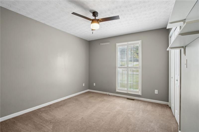 6604 Windbrook Way Flowery Branch, GA 30542 - Photo 40 of 64 an empty room with ceiling fan and windows
