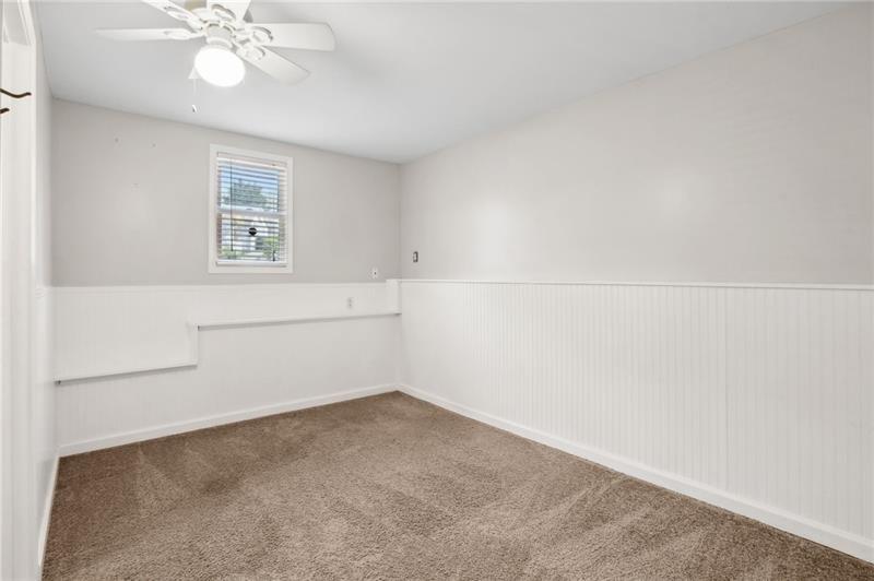 6604 Windbrook Way Flowery Branch, GA 30542 - Photo 43 of 64 an empty room with a chandelier fan and windows