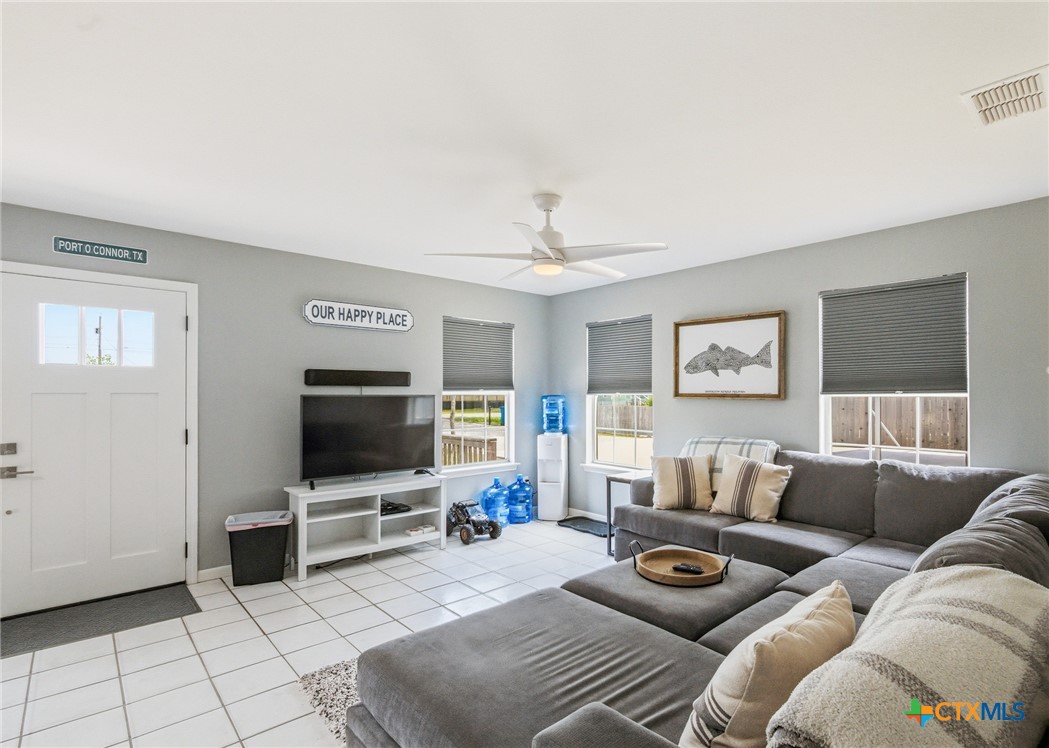 77 Carrie Street Port O'Connor, TX 77982 - Photo 15 of 32 a living room with furniture and a flat screen tv