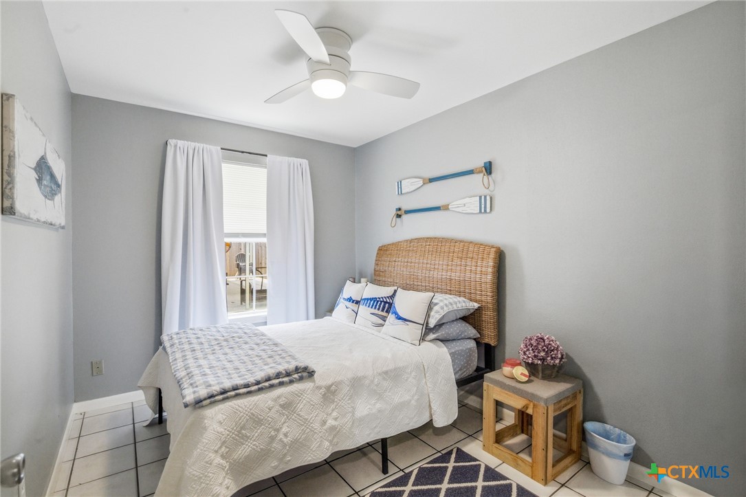 77 Carrie Street Port O'Connor, TX 77982 - Photo 18 of 32 a bedroom with a bed and a window