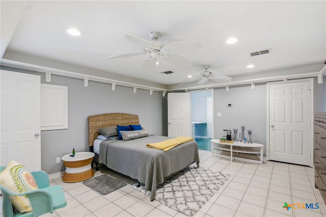 77 Carrie Street Port O'Connor, TX 77982 - Photo 21 of 32 a bedroom with a bed and utility room