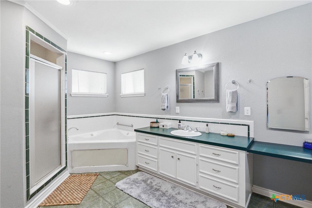77 Carrie Street Port O'Connor, TX 77982 - Photo 25 of 32 a bathroom with a sink a mirror and a toilet