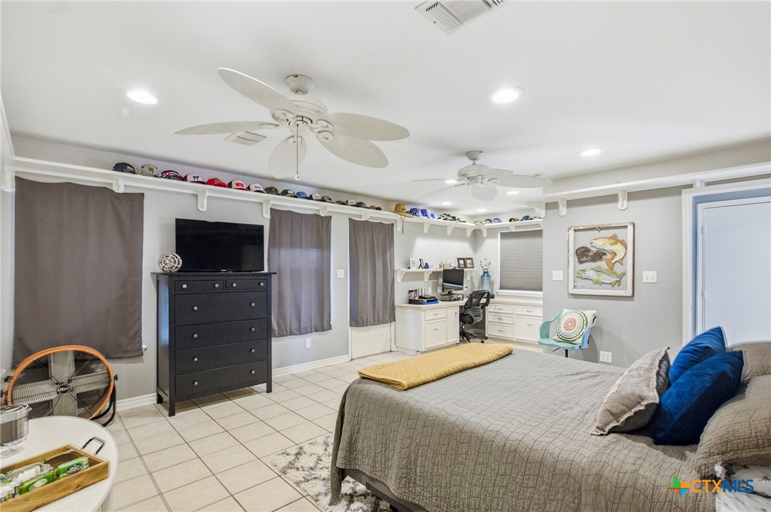 77 Carrie Street Port O'Connor, TX 77982 - Photo 26 of 32 a bedroom with a bed and a tv