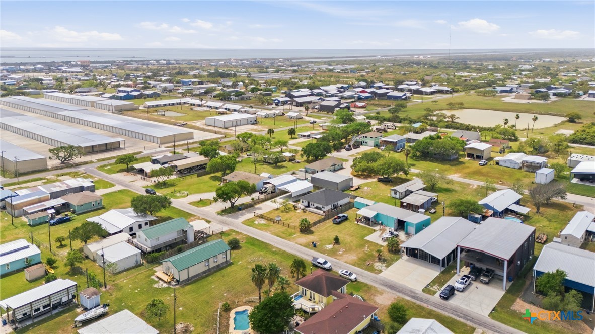 77 Carrie Street Port O'Connor, TX 77982 - Photo 4 of 32 an aerial view of residential building with parking