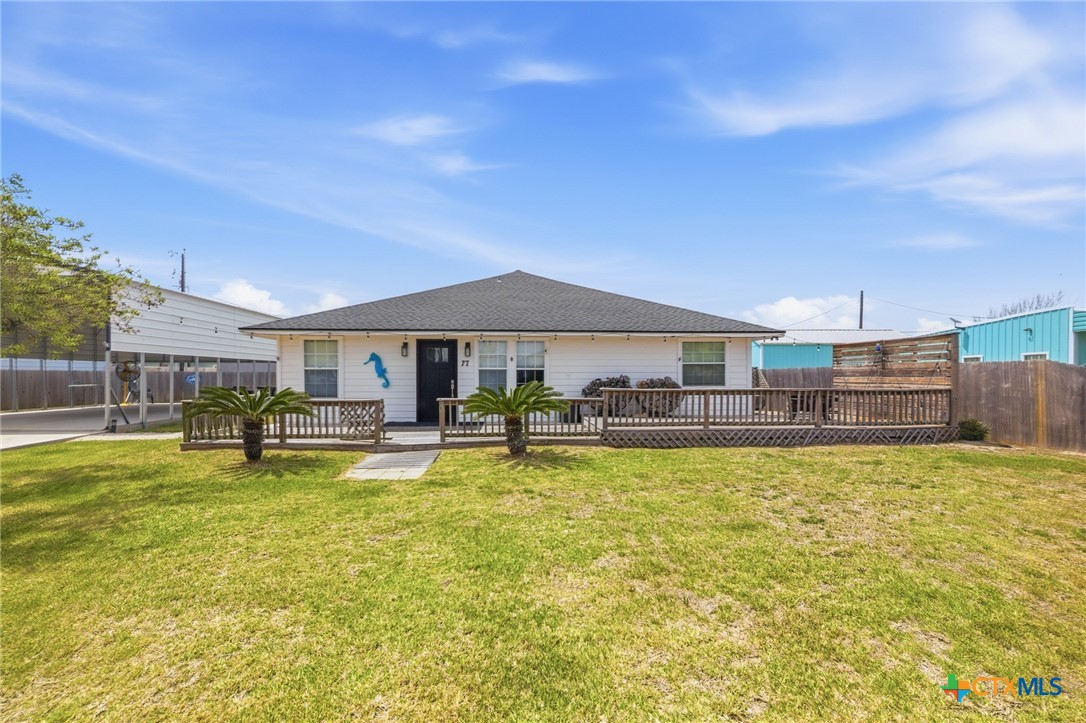 77 Carrie Street Port O'Connor, TX 77982 - Photo 8 of 32 a view of a house with swimming pool and a yard