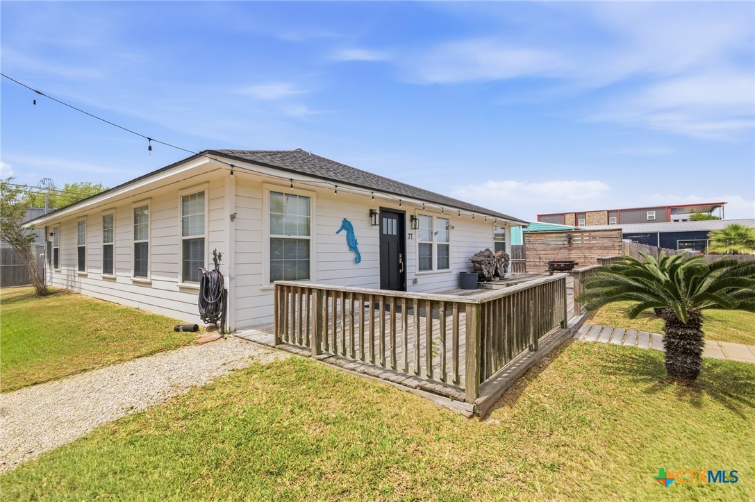 77 Carrie Street Port O'Connor, TX 77982 - Photo 9 of 32 a view of a house with a wooden deck