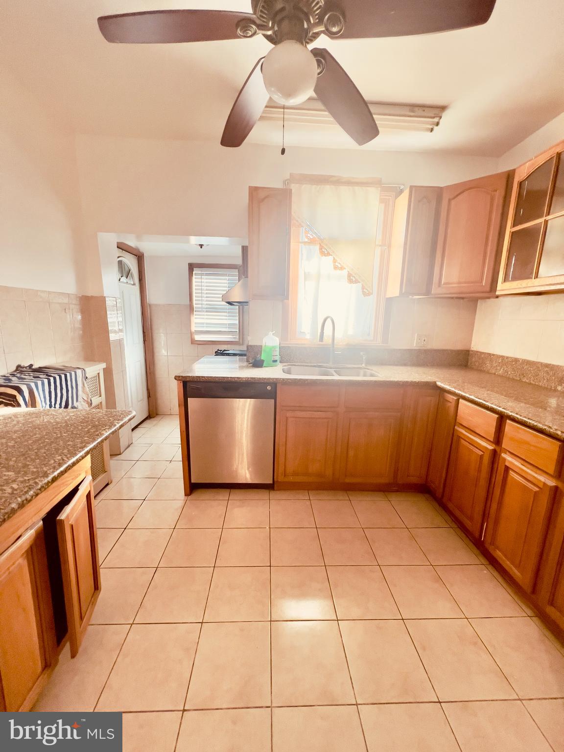 124 West Spencer Street Philadelphia, PA 19120 - Photo 11 of 34 a kitchen with stainless steel appliances granite countertop a sink and cabinets