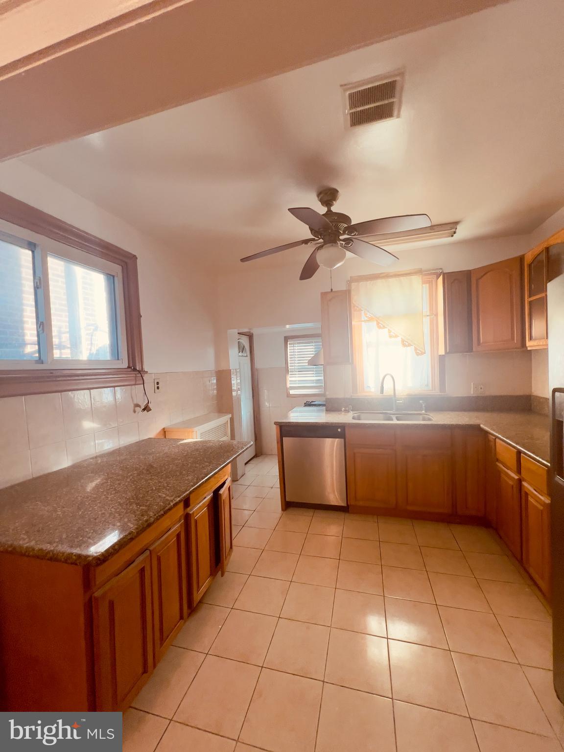 124 West Spencer Street Philadelphia, PA 19120 - Photo 13 of 34 a kitchen with stainless steel appliances granite countertop a sink counter space cabinets and a window