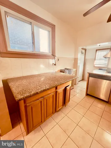 a bathroom with a granite countertop sink and mirror