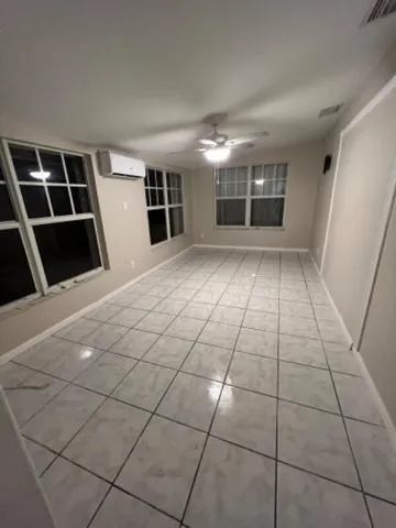 a view of empty room with wooden floor and fireplace