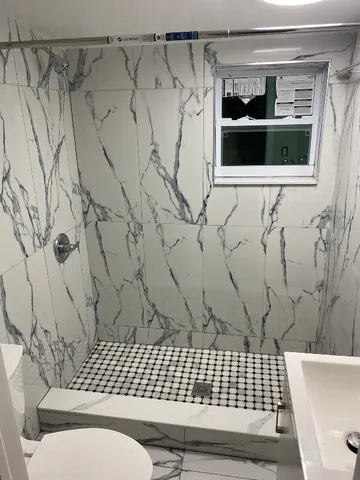 a bathroom with a bathtub and shower