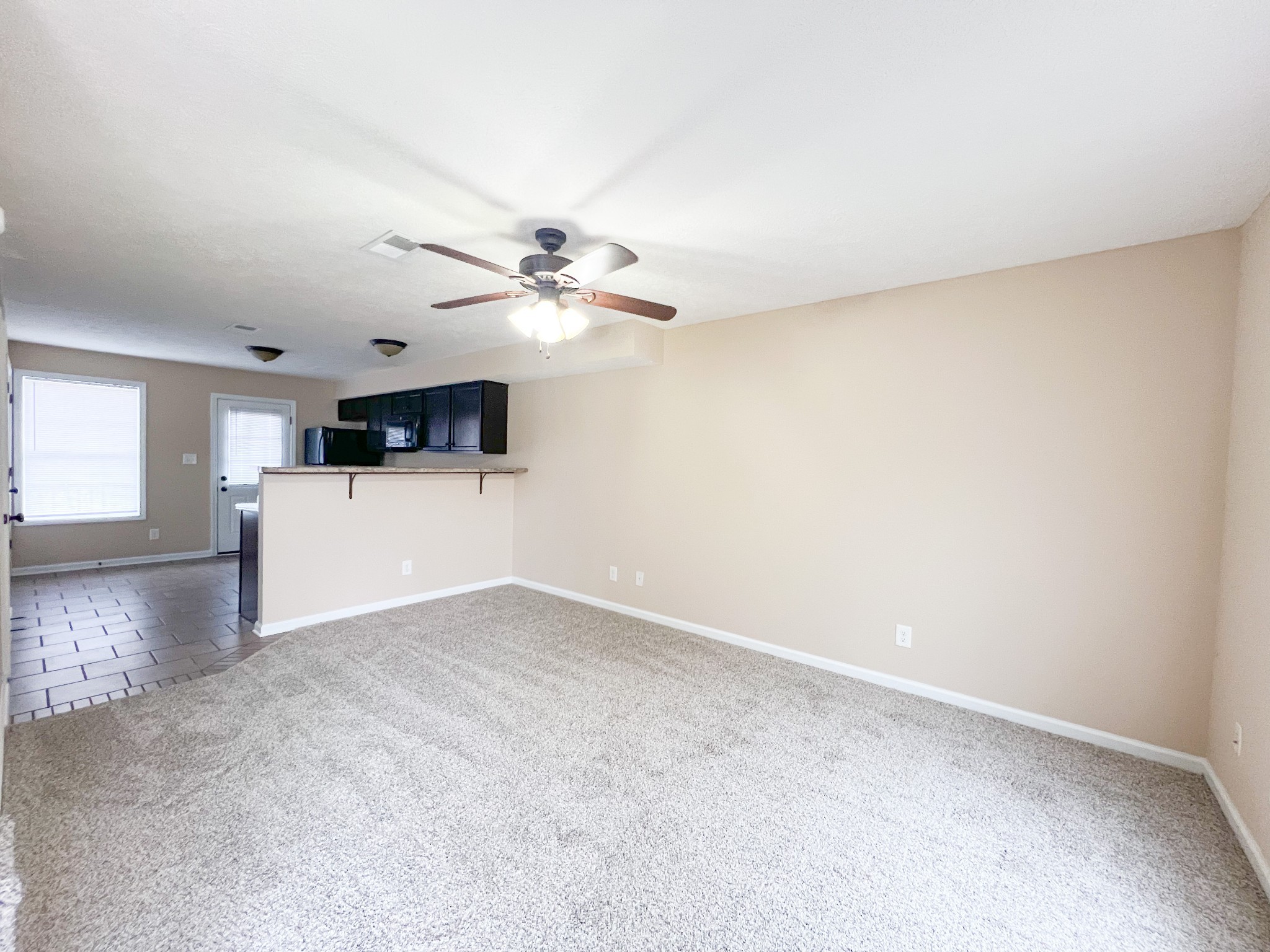 685 Oliver Loop, Unit E Clarksville, TN 37040 - Photo 3 of 6 an empty room with windows and chandelier fan