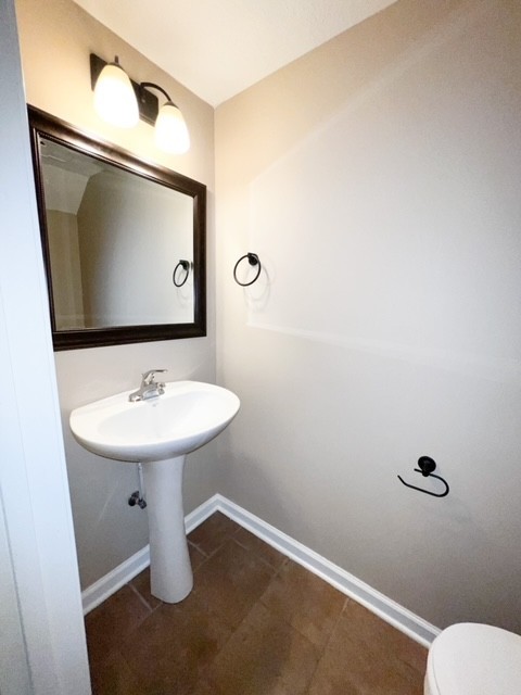 685 Oliver Loop, Unit E Clarksville, TN 37040 - Photo 4 of 6 a bathroom with a sink toilet and mirror