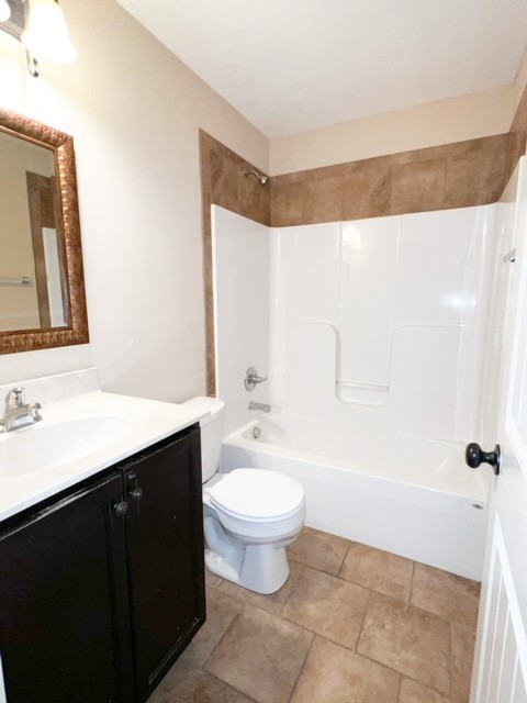 685 Oliver Loop, Unit E Clarksville, TN 37040 - Photo 5 of 6 a bathroom with a sink a toilet and a mirror