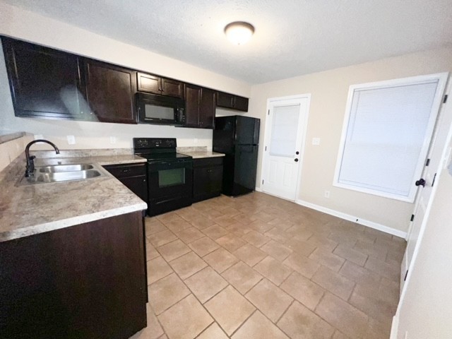 685 Oliver Loop, Unit E Clarksville, TN 37040 - Photo 6 of 6 a kitchen with stainless steel appliances a sink a stove a microwave a sink a refrigerator and cabinets
