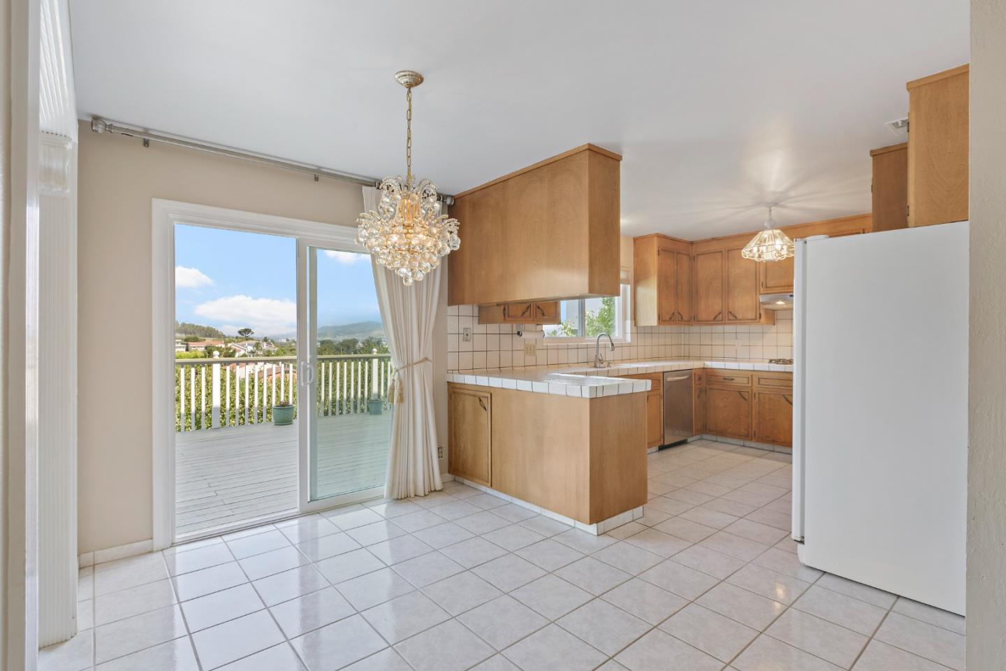 750 Clearfield Drive Millbrae, CA 94030 - Photo 16 of 35 a kitchen with a sink a counter top space cabinets and stainless steel appliances