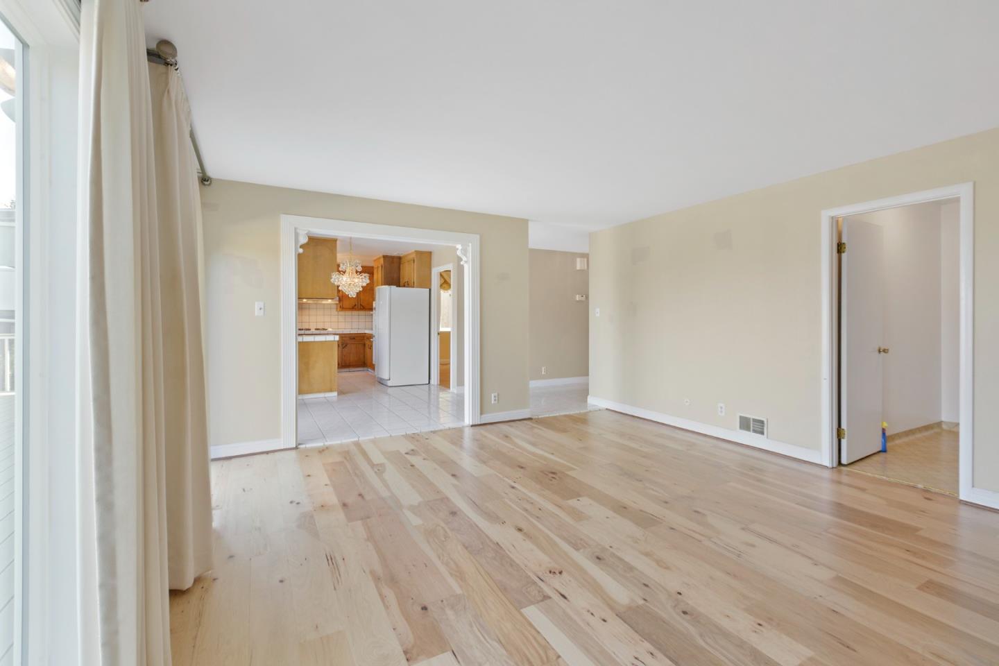 750 Clearfield Drive Millbrae, CA 94030 - Photo 19 of 35 a view of an empty room with wooden floor and a window