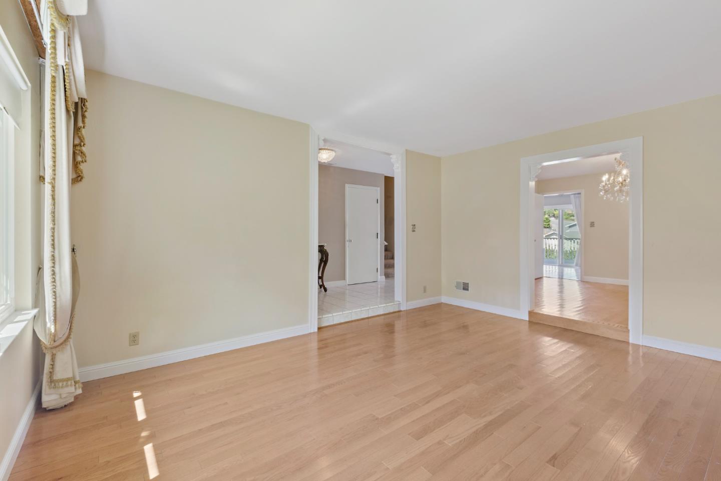750 Clearfield Drive Millbrae, CA 94030 - Photo 8 of 35 an empty room with wooden floor and windows