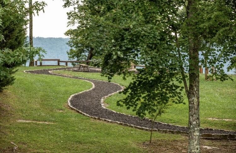 3261 Crockett Pointe Jasper, TN 37347 - Photo 15 of 31 a view of a garden with a bench in the background