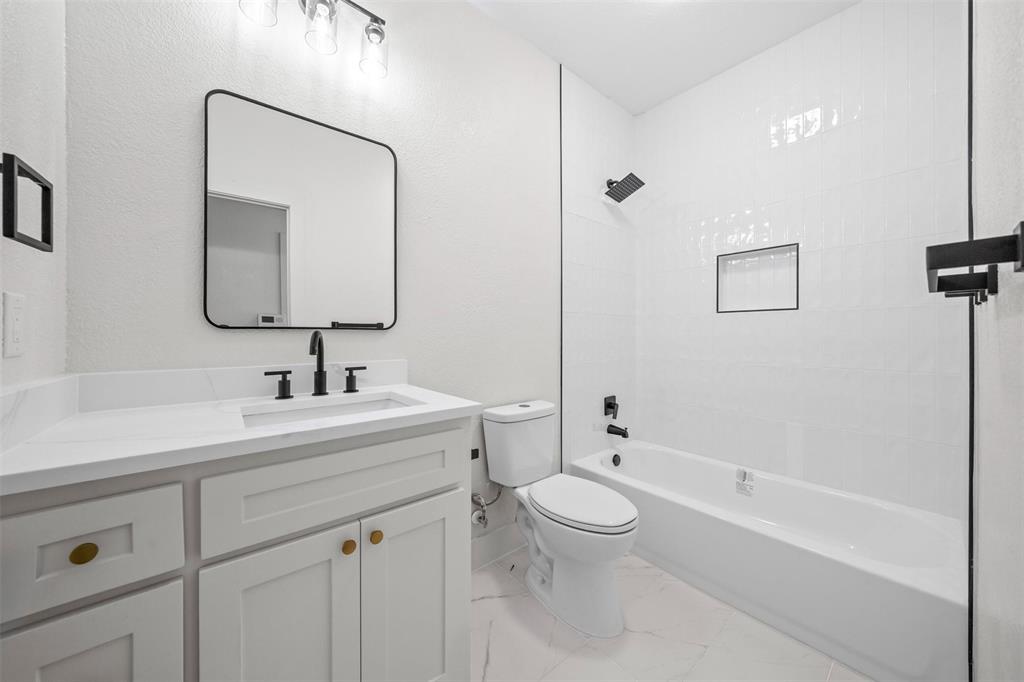 2104 Old McGarrah Road McKinney, TX 75072 - Photo 18 of 35 White vanity with a solid surface countertop and undermount sink
