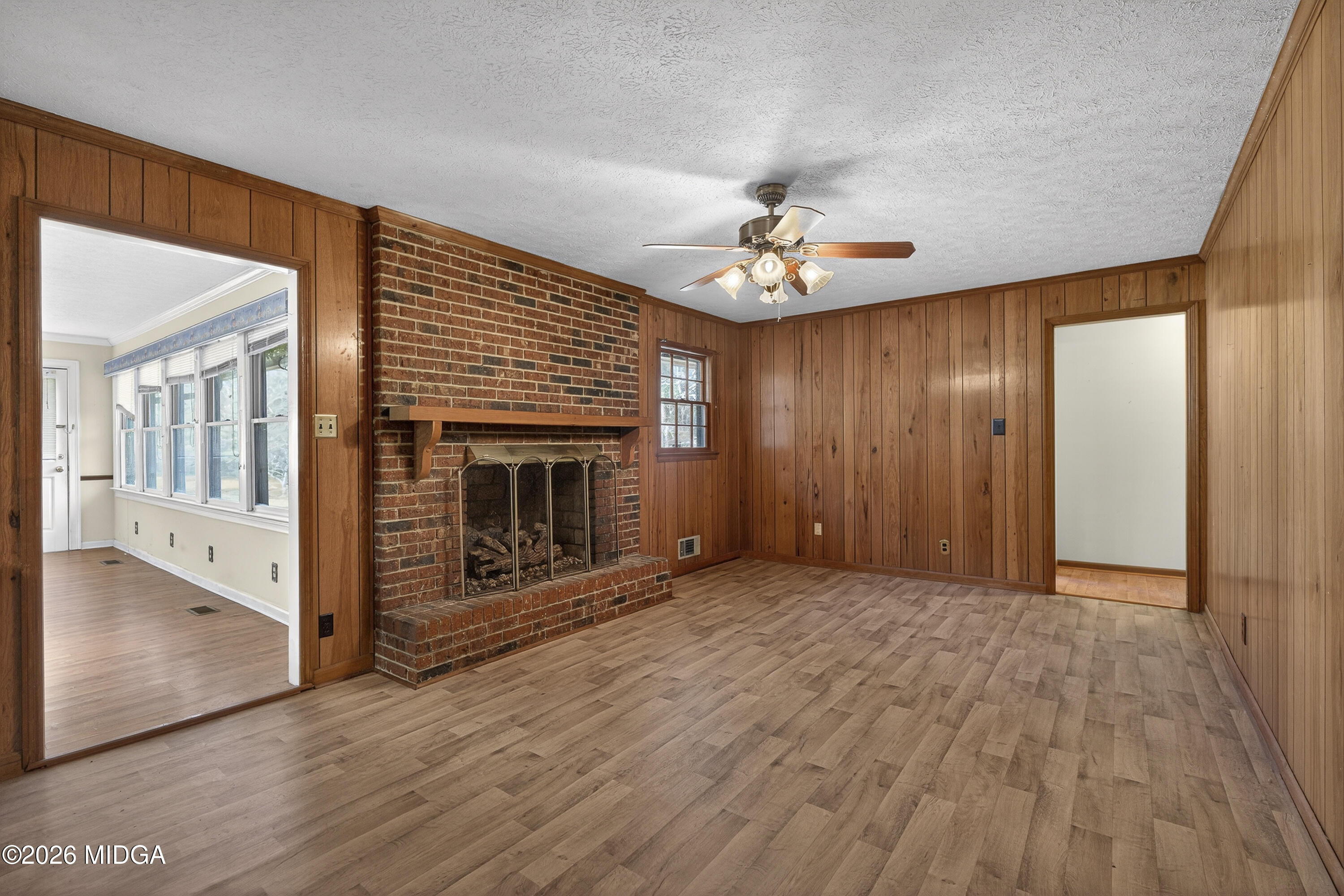1775 Lower Hartley Bridge Road Byron, GA 31008 - Photo 15 of 51 an empty room with wooden floor fireplace and windows