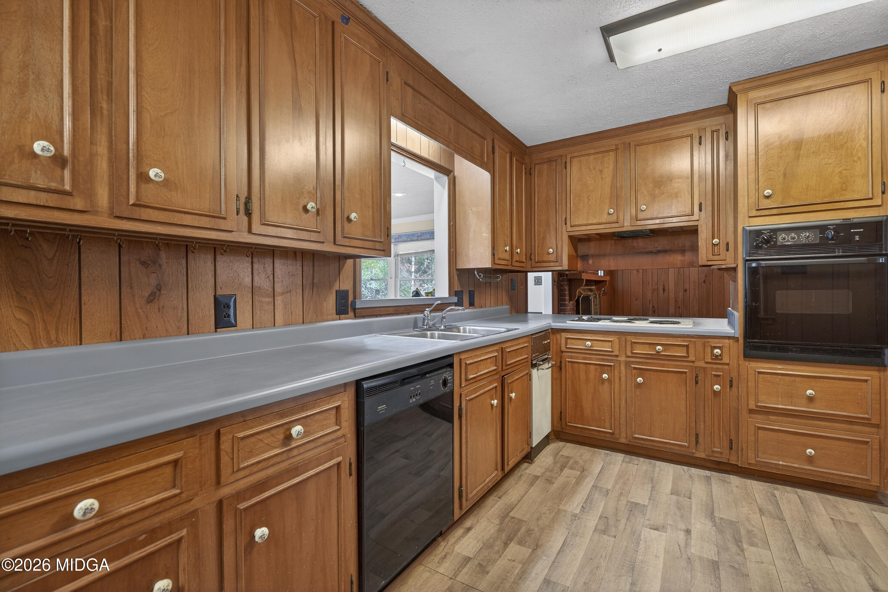 1775 Lower Hartley Bridge Road Byron, GA 31008 - Photo 22 of 51 a kitchen with stainless steel appliances granite countertop a sink a stove and cabinets