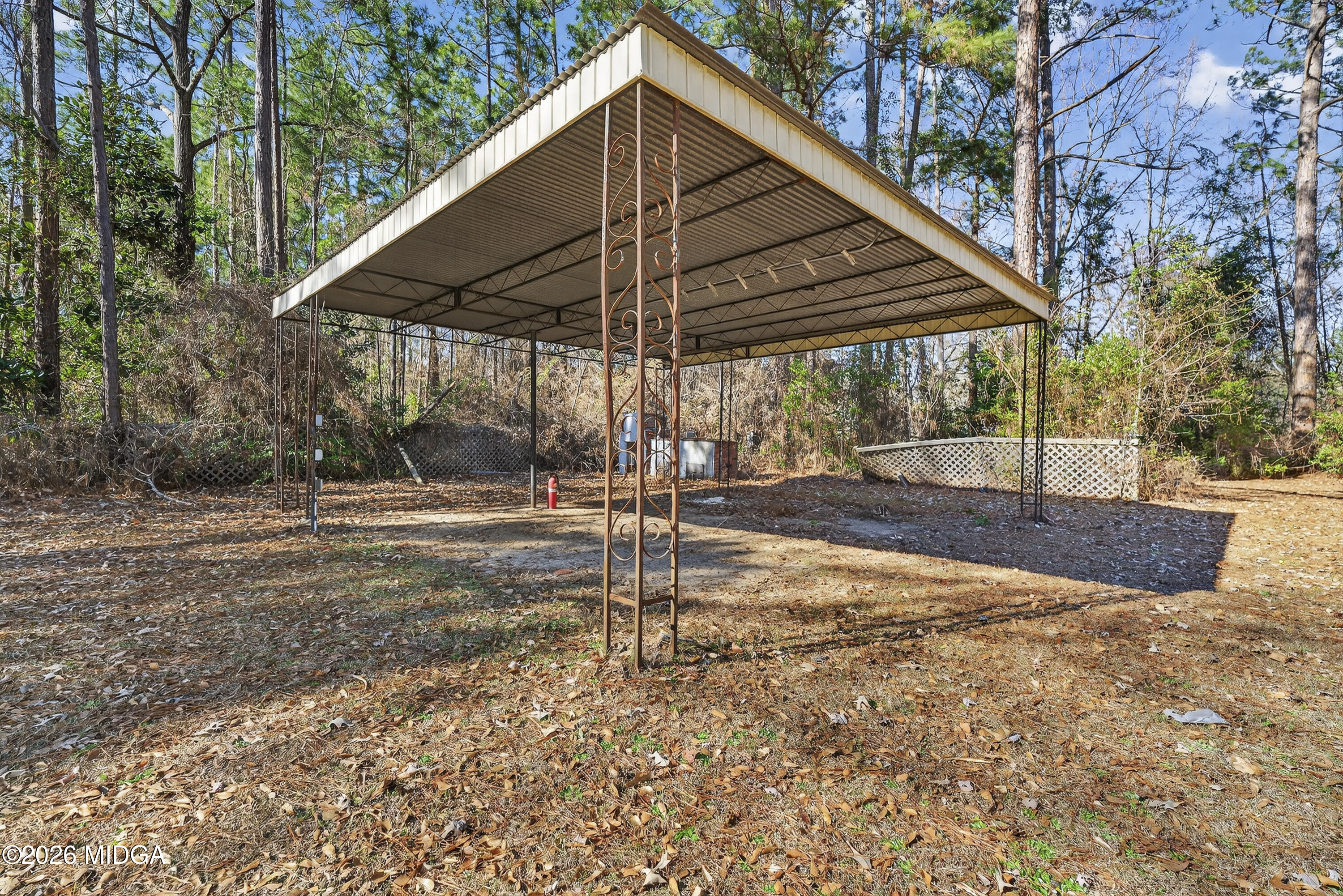 1775 Lower Hartley Bridge Road Byron, GA 31008 - Photo 27 of 51 a backyard of a house with table and chairs