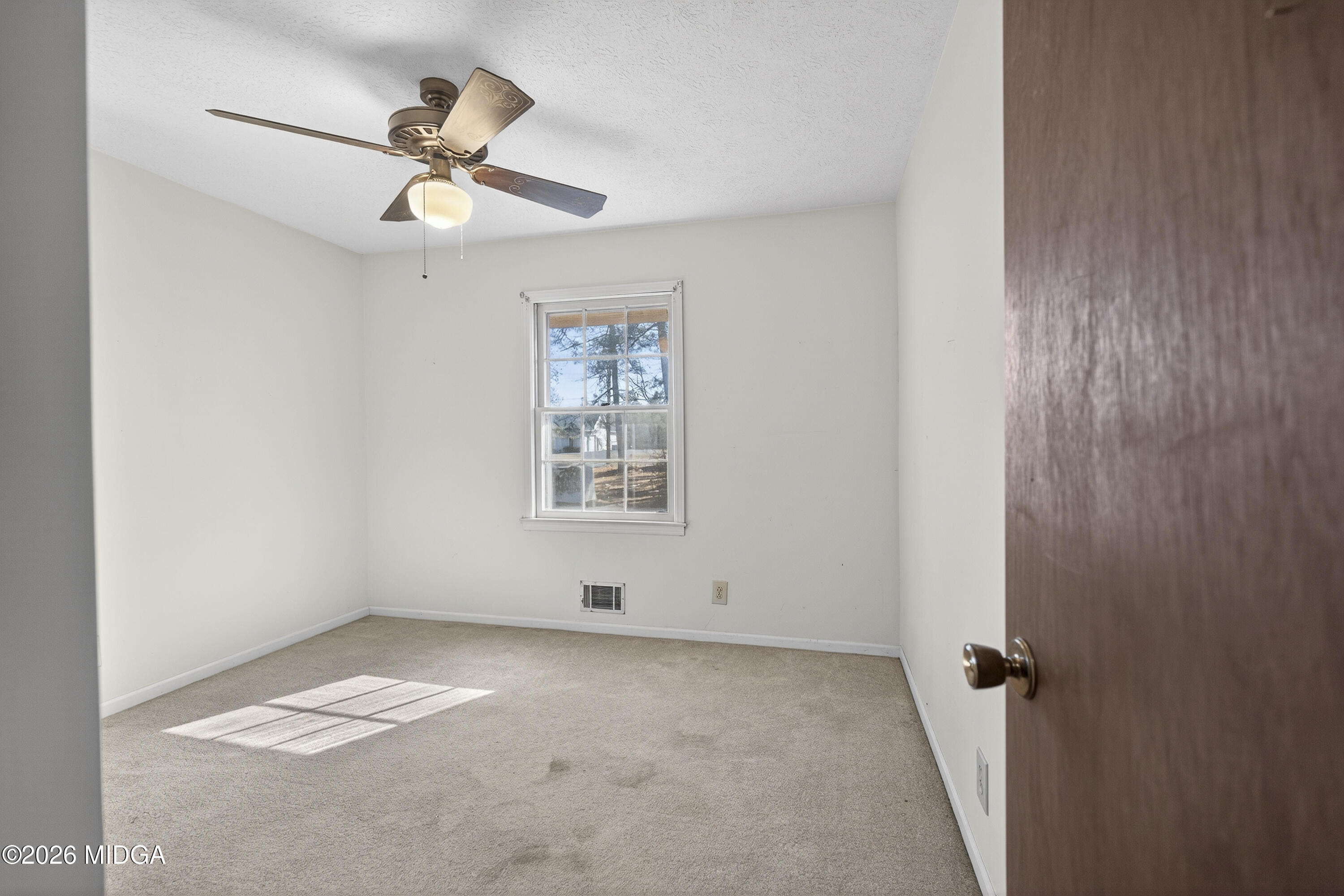 1775 Lower Hartley Bridge Road Byron, GA 31008 - Photo 37 of 51 an empty room with windows and fan