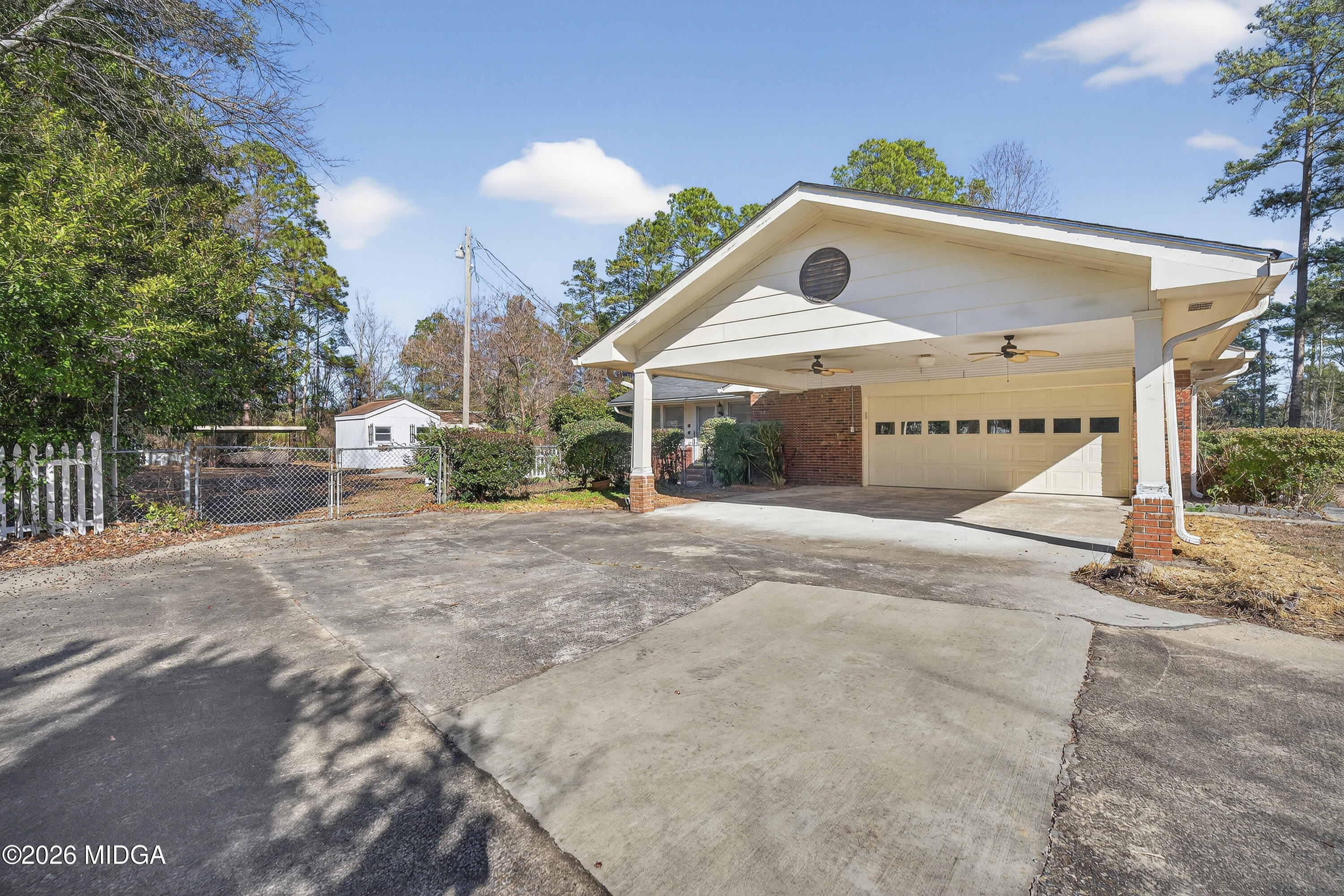 1775 Lower Hartley Bridge Road Byron, GA 31008 - Photo 6 of 51 a front view of a house with a yard and garage