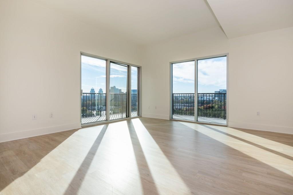 4561 Olde Perimeter Way, Unit 1701 Atlanta, GA 30346 - Photo 11 of 60 a view of empty room with wooden floor and fan