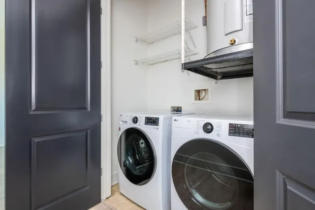 a living room with furniture a flat screen tv and kitchen view