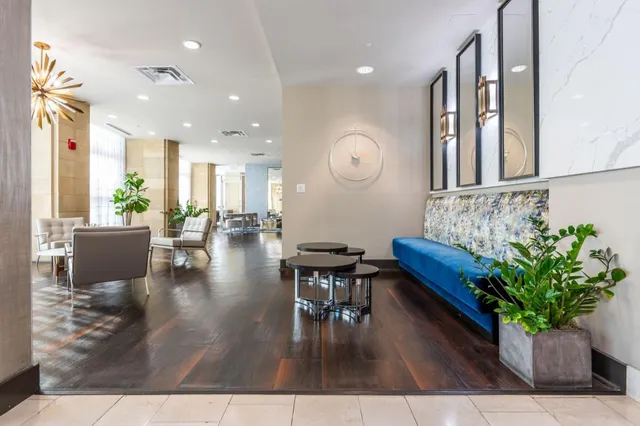 a living room with furniture and large windows
